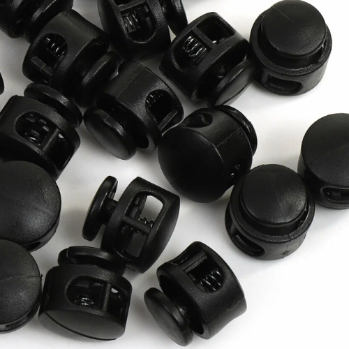  Фиксатор для шнура 2 отверстия 27001 СБ Бочка бол. цв.Черный (уп.50/500 шт.)  ТриКатушки